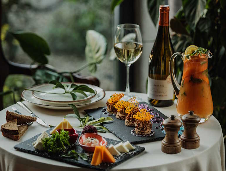 Side view of a table with cheese plate and pate on it